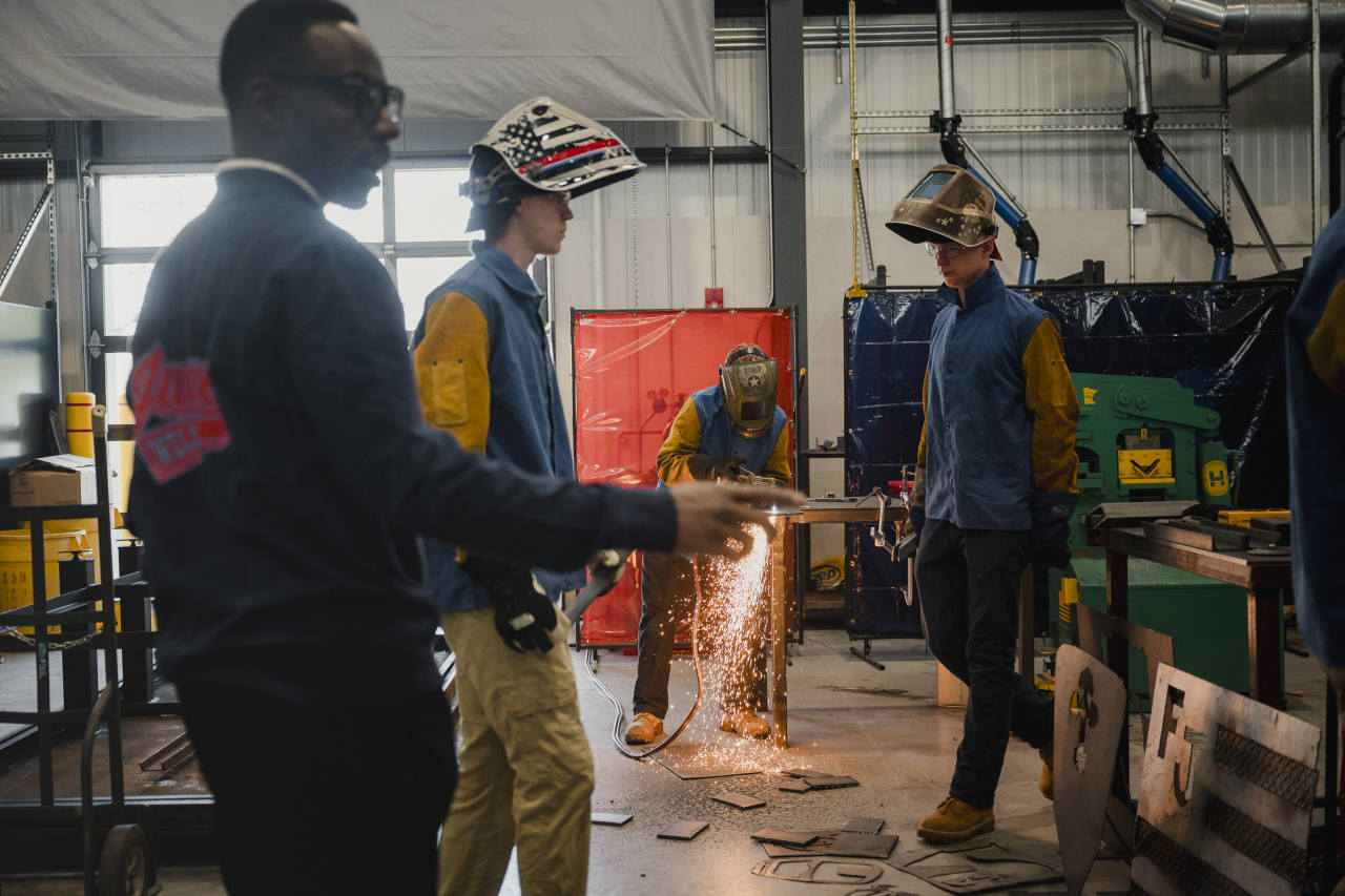 Welding instructor Joe Williams, left, teaches students at Father Judge High School in Philadelphia.